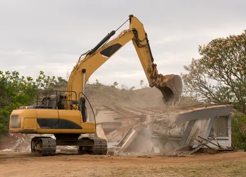 An image explaining the knock-down rebuild process, featuring a before-and-after comparison of a project by Gurzora Homes.